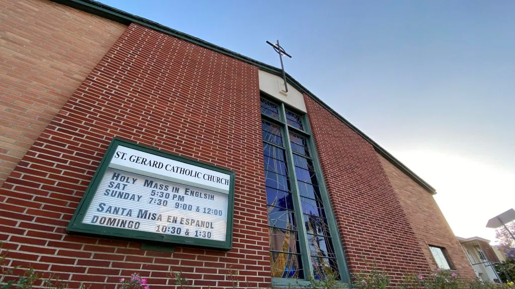 An old sign advertising the time for mass on the facade of the closed St. Gerard Majella Catholic Church in Los Angeles on May 23, 2020. (Chris Delmas/AFP via Getty Images)
