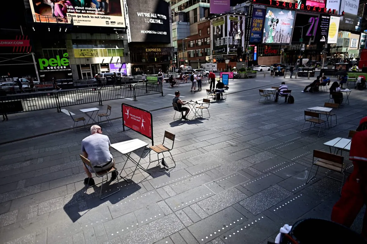 People sit on tables, respecting social distancing, at Times Square in New York City on June 22, 2020. (Johannes Eisele/AFP via Getty Images)