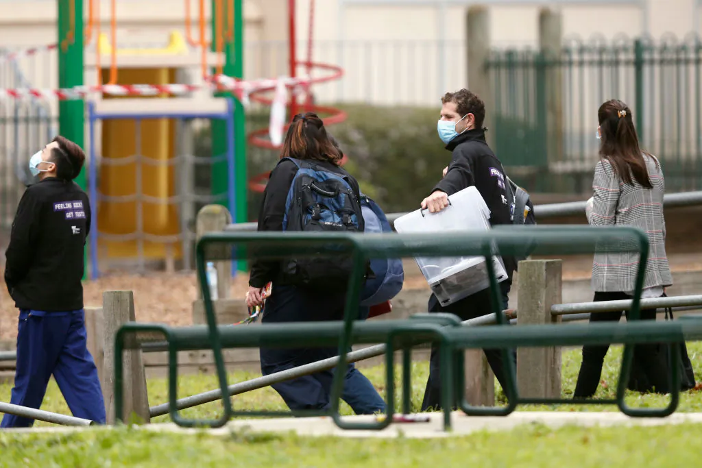 Government employees are seen entering the Alfred Street Public Housing Complex in North Melbourne on July 17, 2020 in Melbourne, Australia. (Darrian Traynor/Getty Images)