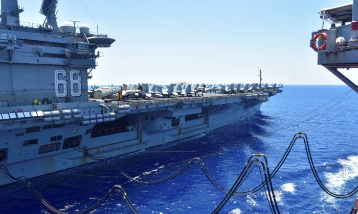 The U.S. Navy aircraft carrier USS Nimitz receives fuel from the Henry J. Kaiser-class fleet replenishment oiler USNS Tippecanoe during an underway replenishment in the South China Sea on July 7, 2020. (U.S. Navy/Christopher Bosch/Handout via Reuters)