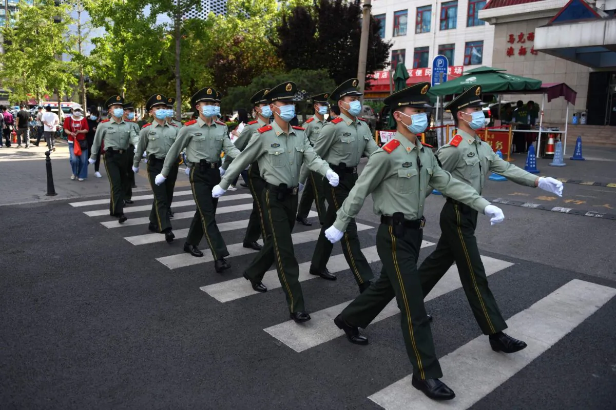 Paramilitary police officers patrol in a shopping area on the closing day of the Chinese People's Political Consultative Conference (CPPCC) in Beijing on May 27, 2020. (Greg Baker/AFP via Getty Images)