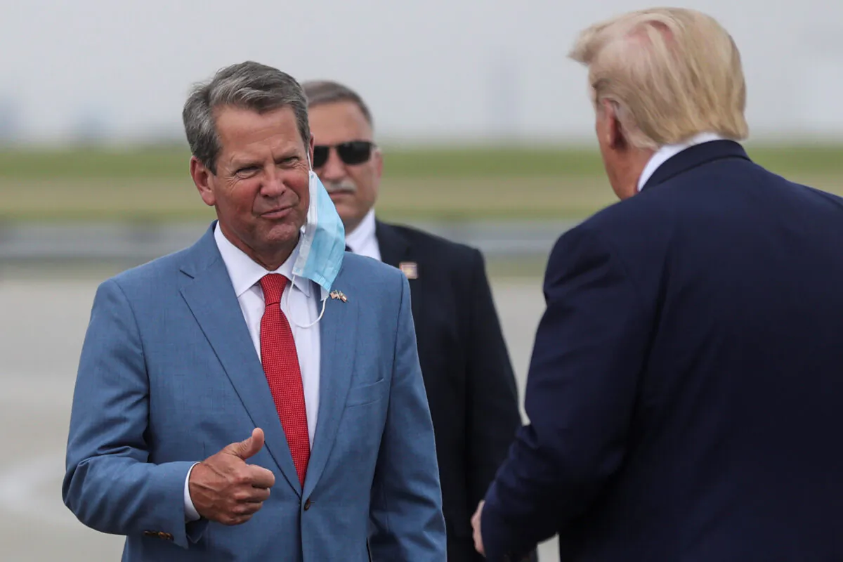 President Donald Trump is greeted by Georgia Gov. Brian Kemp as he arrives at Hartsfield-Jackson Atlanta International Airport in Atlanta, Ga., on July 15, 2020. (Jonathan Ernst/Reuters)