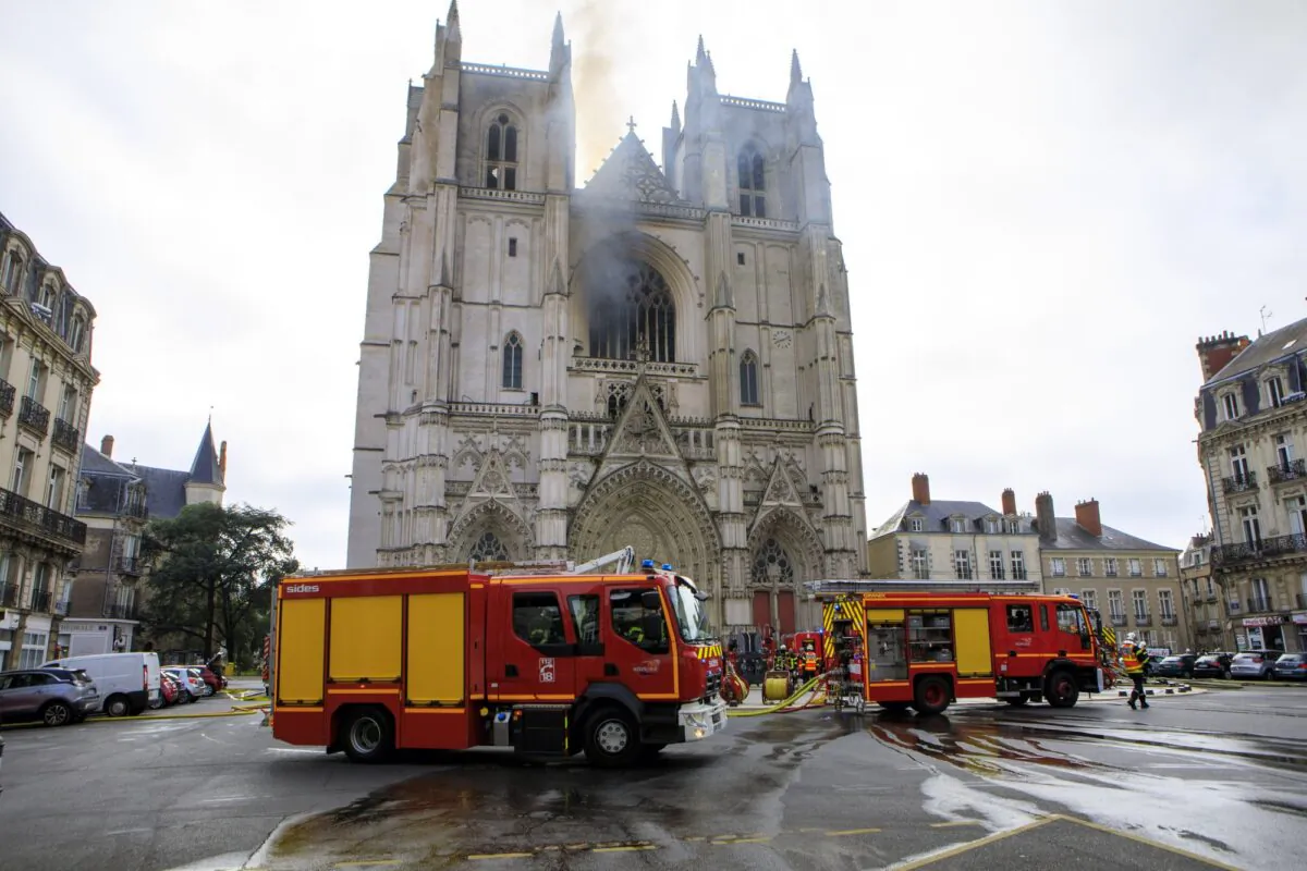 Fire fighters brigade work to extinguish the blaze at the Gothic St. Peter and St. Paul Cathedral, in Nantes, western France on July 18, 2020. (Laetitia Notarianni/AP Photo)