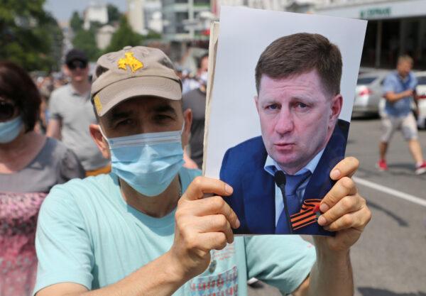 A man wearing a protective face mask takes part in a rally