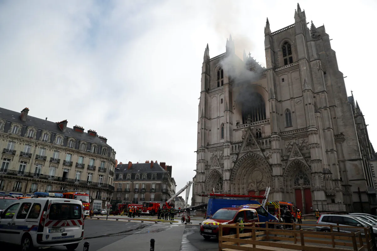 French firefighters gather at the scene of a blaze at the Cathedral of Saint Pierre and Saint Paul in Nantes, France, on July 18, 2020. (Stephane Mahe/Reuters)
