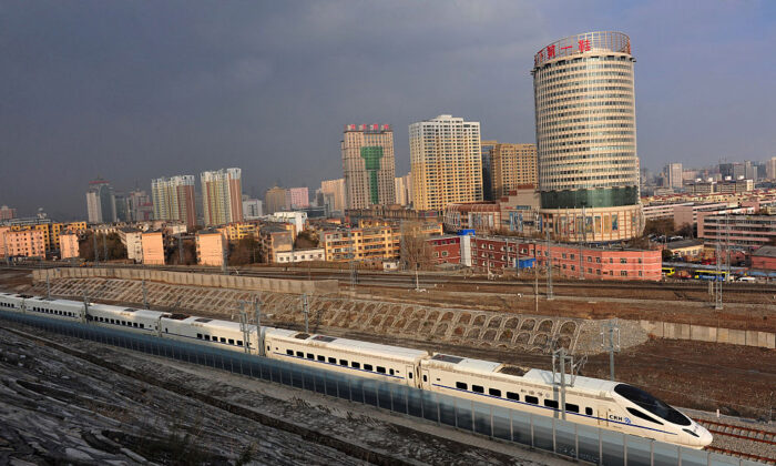 A CRH high-speed train runs across Urumqi city during its test run in Urumqi, the capital of China's Xinjiang region, on Nov. 11, 2014. (VCG/VCG via Getty Images)