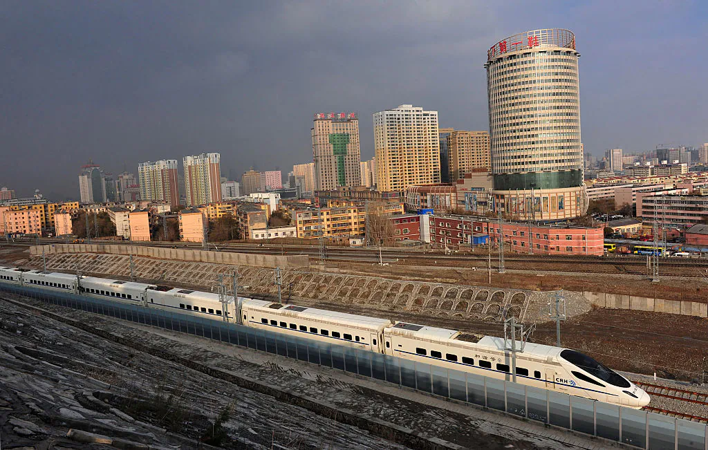 A CRH high-speed train runs across Urumqi city during its test run in Urumqi, the capital of China's Xinjiang region, on Nov. 11, 2014. (VCG/VCG via Getty Images)