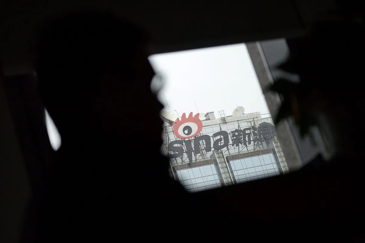 Signage of Sina Weibo (C), widely known as China's version of Twitter, is displayed in Beijing on April 16, 2014. (WANG ZHAO/AFP via Getty Images)