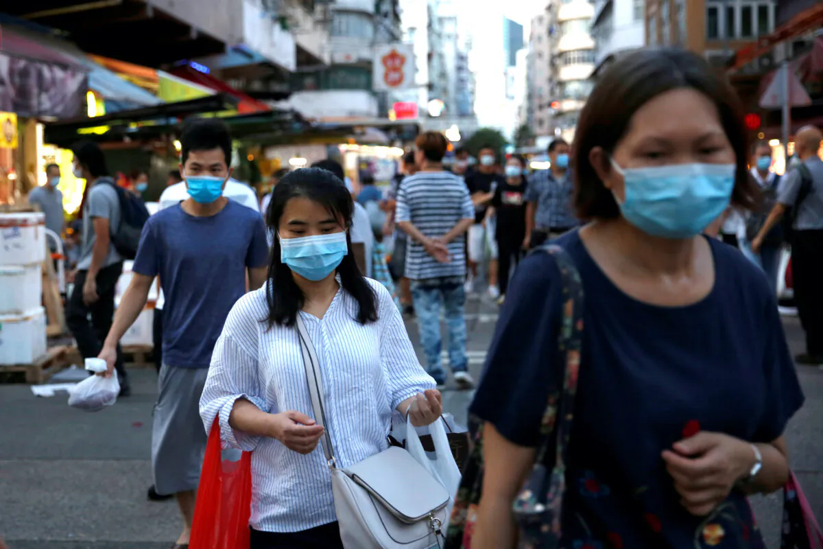 People wear surgical masks at a wet market following the COVID-19 outbreak at Sham Shui Po, one of the oldest districts in Hong Kong on July 17, 2020. (Tyrone Siu/Reuters)