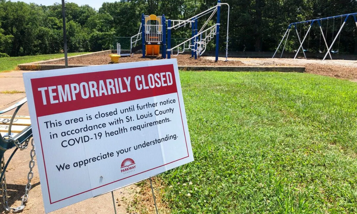 A sign alongside a playground at Hanna Woods Elementary School in the Parkway School District in suburban St. Louis indicates that the playground is closed due to the coronavirus pandemic, on July 18, 2020. (Jim Salter/AP Photo)