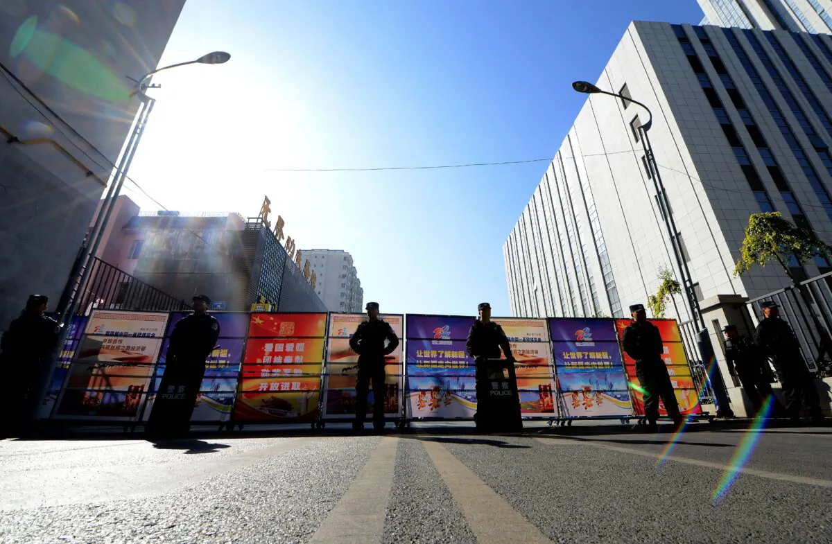 Chinese police seal off the road leading to the Urumqi Intermediate People's court in Urumqi, farwest China's Xinjiang region on Sept. 17, 2014. (GOH CHAI HIN/AFP via Getty Images)