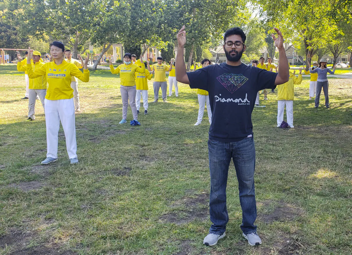 Vijay Kumar medidates with fellow Falun Dafa practitioners at Townsend Park in San Jose on July 18, 2020. (David Lam/The Epoch Times)