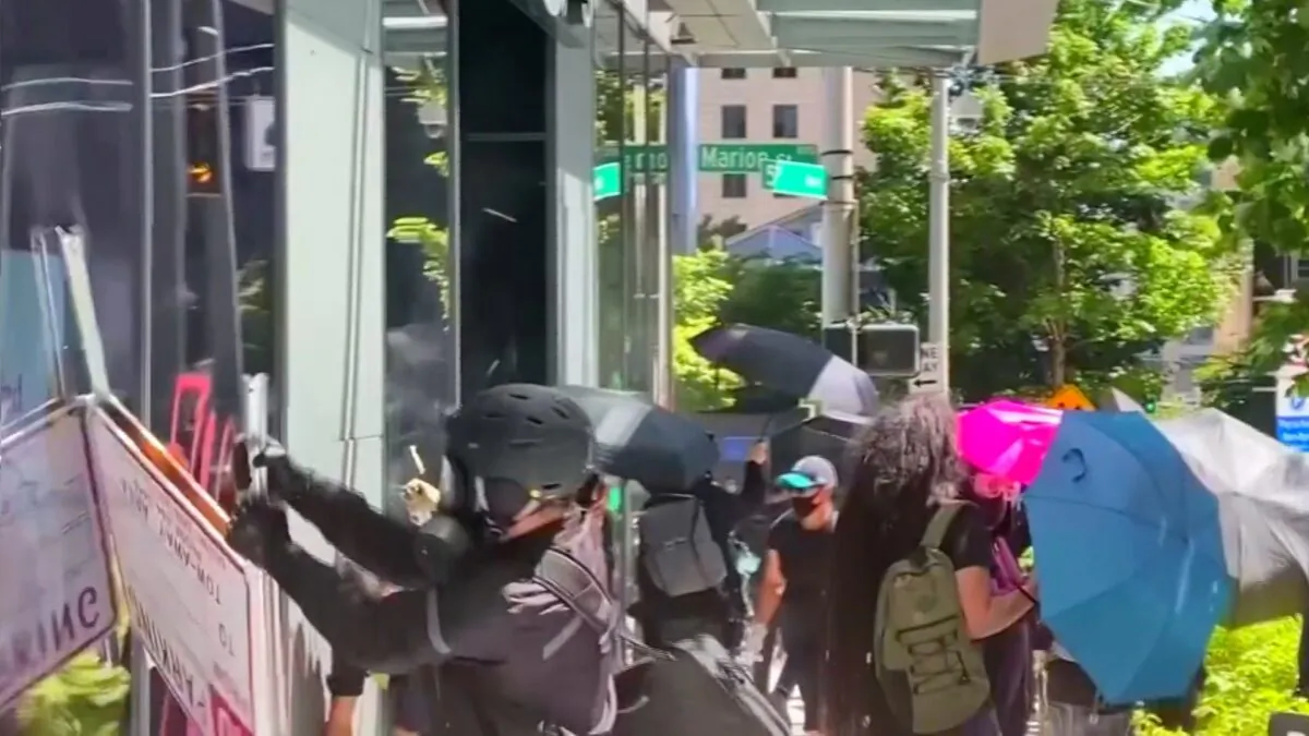 Rioters try to break into an Amazon store in Seattle on July 19, 2020. (Katie Daviscourt via Reuters)