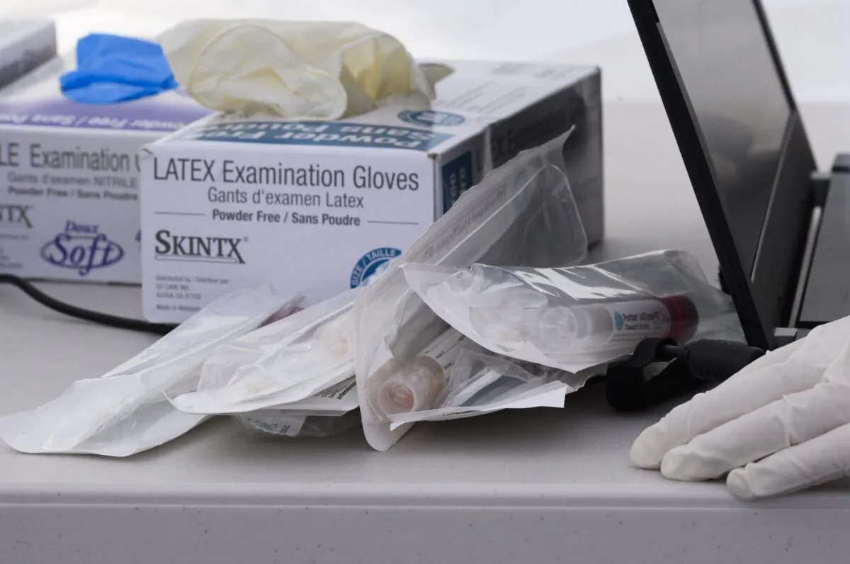 Nasal swab test kits and medical gloves are seen at a mobile COVID-19 testing station in a public school parking area in Compton, Calif., on April 28, 2020. (Robyn Beck/AFP via Getty Images)