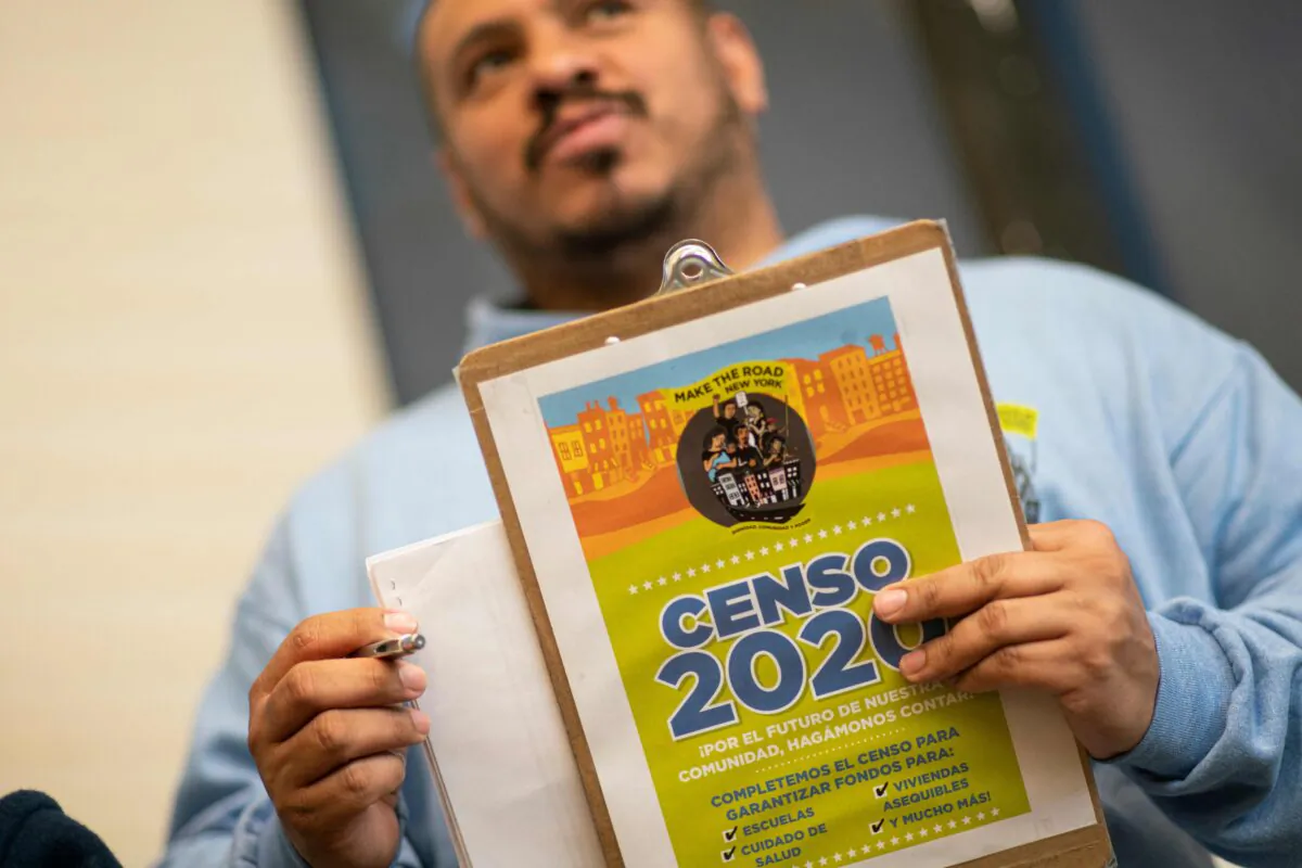Douglas Carrasquell of the organization Make the Road New York holds documents as he attends a training meeting about National Census in Queens in New York City on March 13, 2020. (Kena Betancur/AFP via Getty Images)