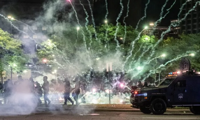 Tear gas canisters explode near Detroit Police units responding to protests in Detroit, Mich., on May 30, 2020. (Seth Herald/AFP/Getty Images)