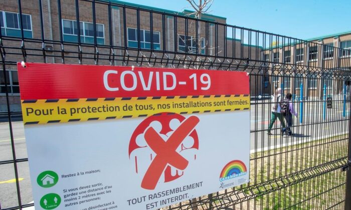 Signage warns of the closure of an elementary school amid the pandemic in Montreal on May 14, 2020. (Ryan Remiorz/The Canadian Press)