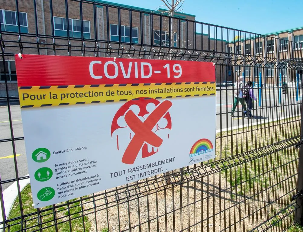 Signage warns of the closure of an elementary school amid the pandemic in Montreal on May 14, 2020. (Ryan Remiorz/The Canadian Press)