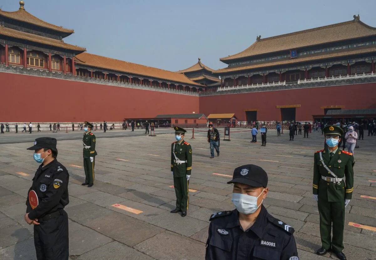 Chinese paramilitary police and guards stand in front of the entrance to the Forbidden City in Beijing on May 1, 2020.   (Kevin Frayer/Getty Images)