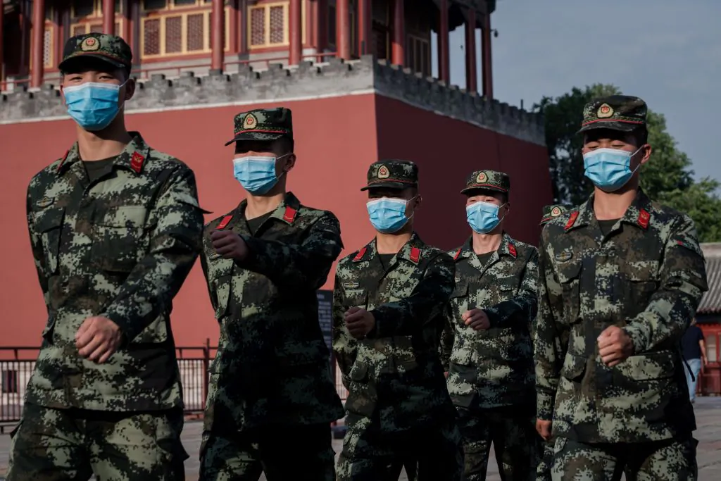 Paramilitary police officers march next to the entrance to the Forbidden City in Beijing on May 22, 2020. (Nicolas Asfouri/AFP via Getty Images)
