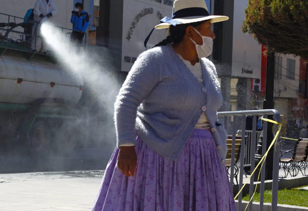 Amid the COVID-19 pandemic, municipal workers disinfect the main streets of Puno, in the highlands of Peru close to the border with Bolivia, on July 17, 2020. (CARLOS MAMANI/AFP via Getty Images)