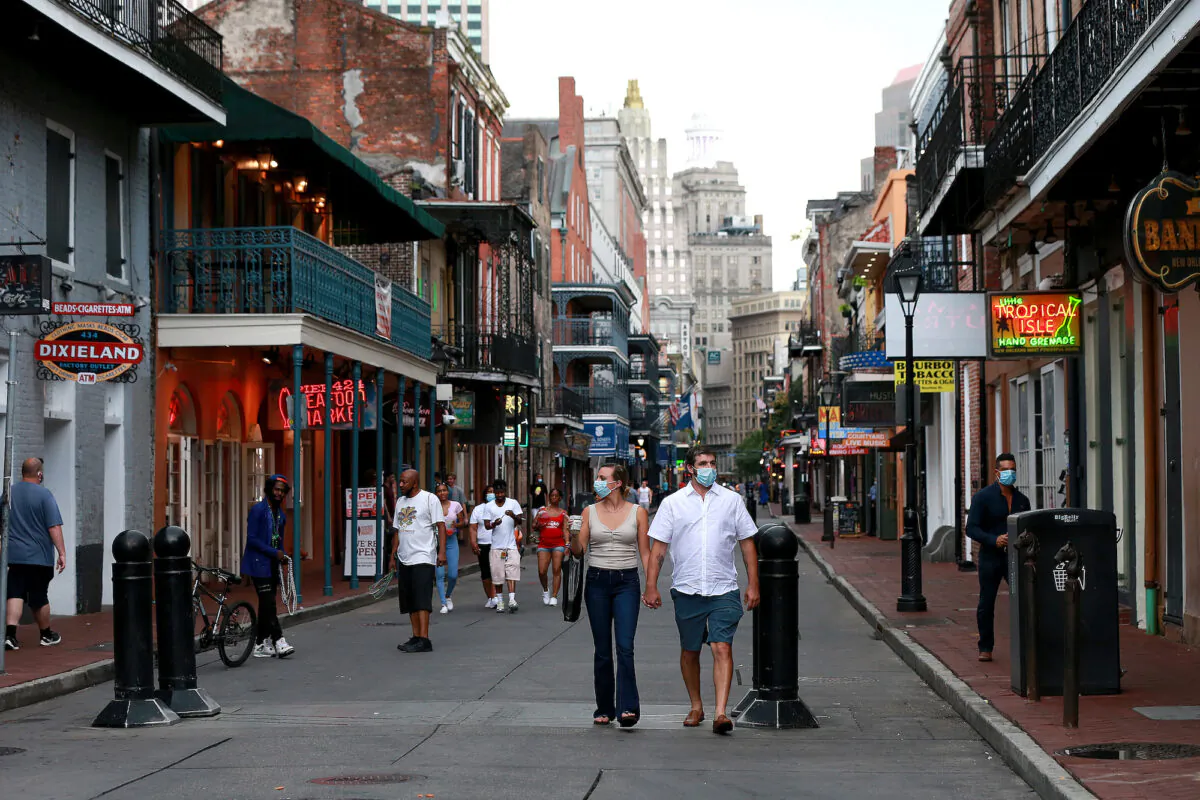 Pedestrians are seen walking along Bourbon Street in the French Quarter in New Orleans, Louisiana, on July 14, 2020. (Sean Gardner/Getty Images)