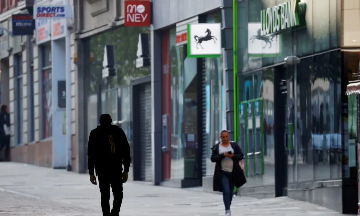 People are seen walking on a street in Manchester, following the outbreak of the coronavirus disease (COVID-19), in Manchester, Britain, on May 4, 2020. (Phil Noble/Reuters)