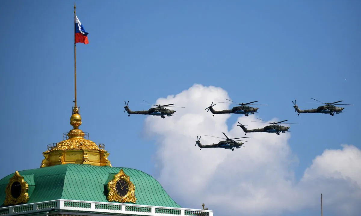 Russian Mi-28N military helicopters fly in formation above the Kremlin and Red Square during the Victory Day Parade in Moscow, Russia, on June 24, 2020. (Host photo agency/Nina Zotina via Reuters)