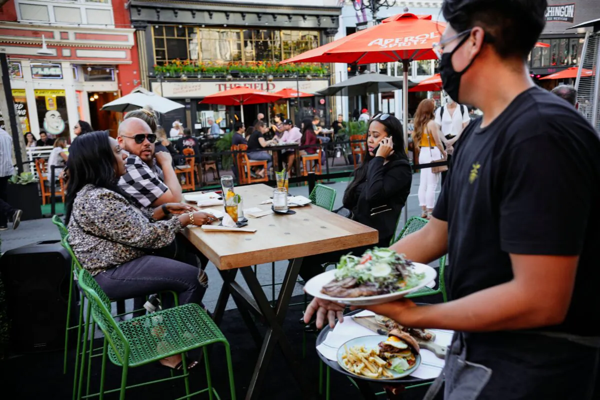 Patrons dine at an outdoor restaurant along 5th Avenue in downtown San Diego, Calif., on, July 17, 2020.  (SANDY HUFFAKER/AFP via Getty Images)