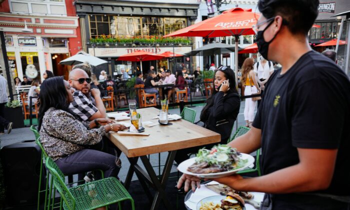Patrons dine at an outdoor restaurant along 5th Avenue in downtown San Diego, Calif., on, July 17, 2020.  (SANDY HUFFAKER/AFP via Getty Images)