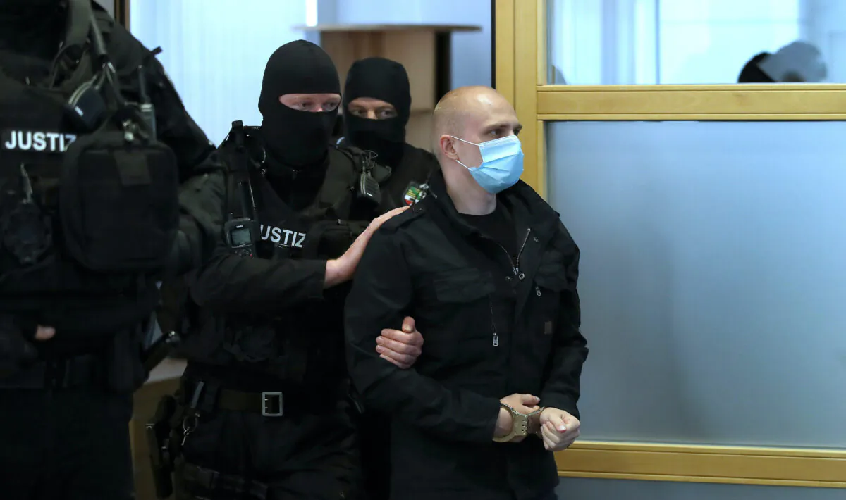 Stephan Balliet, who is accused of shooting two people after an attempt to storm a synagogue in Halle, arrives into the courtroom for the start of his trial, at the district court in Magdeburg, Germany July 21, 2020. (Ronny Hartmann/Pool via Reuters)
