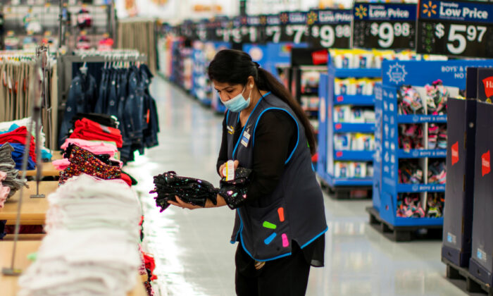 A worker wears a mask while organizing merchandise at a Walmart store, in North Brunswick, N.J., on July 20, 2020. (Eduardo Munoz/Reuters)