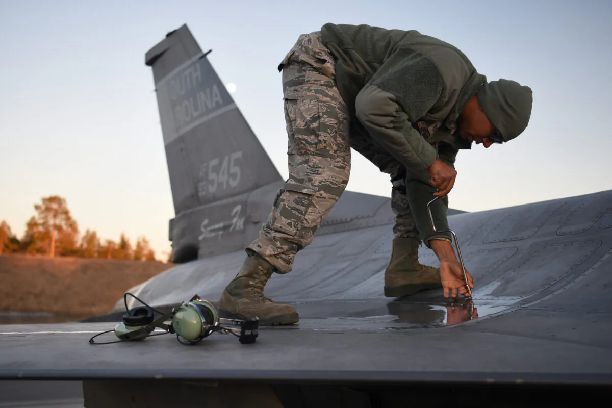 U.S. Air Force Tech. Sgt. Brad Steward secures an aircraft panel after the arrival of an F-16 at Kallax Air Base in Luleå, Sweden, on May 16, 2019 in preparation for Arctic Challenge Exercise 2019. (U.S. Air National Guard photo by Senior Master Sgt. Edward Snyder)