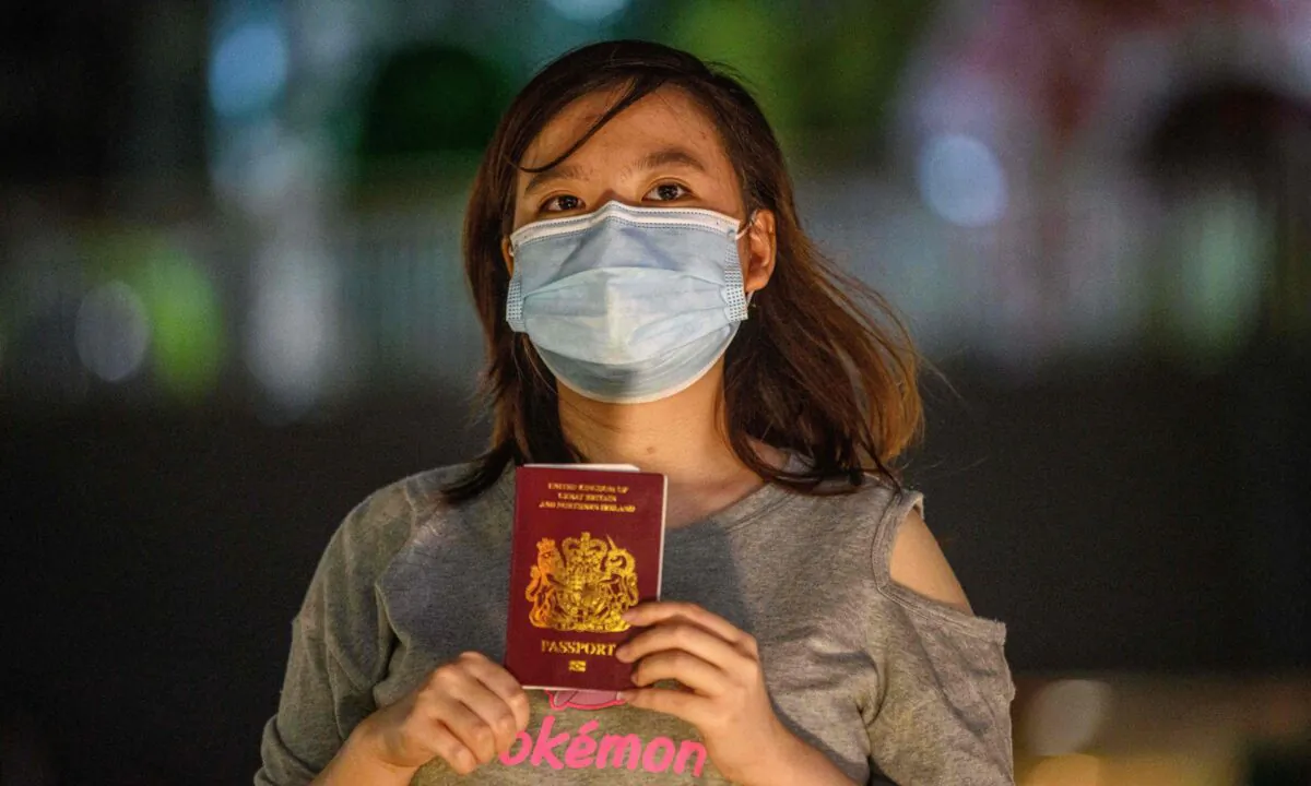 Recent graduate Asuka Law, 23, poses with her British National (Overseas), or BN(O), in her favourite part of the city and the place she would miss the most if she leaves, near a shopping mall, in Kwai Chung, Hong Kong, on June 3, 2020. (Anthony Wallace/AFP via Getty Images)