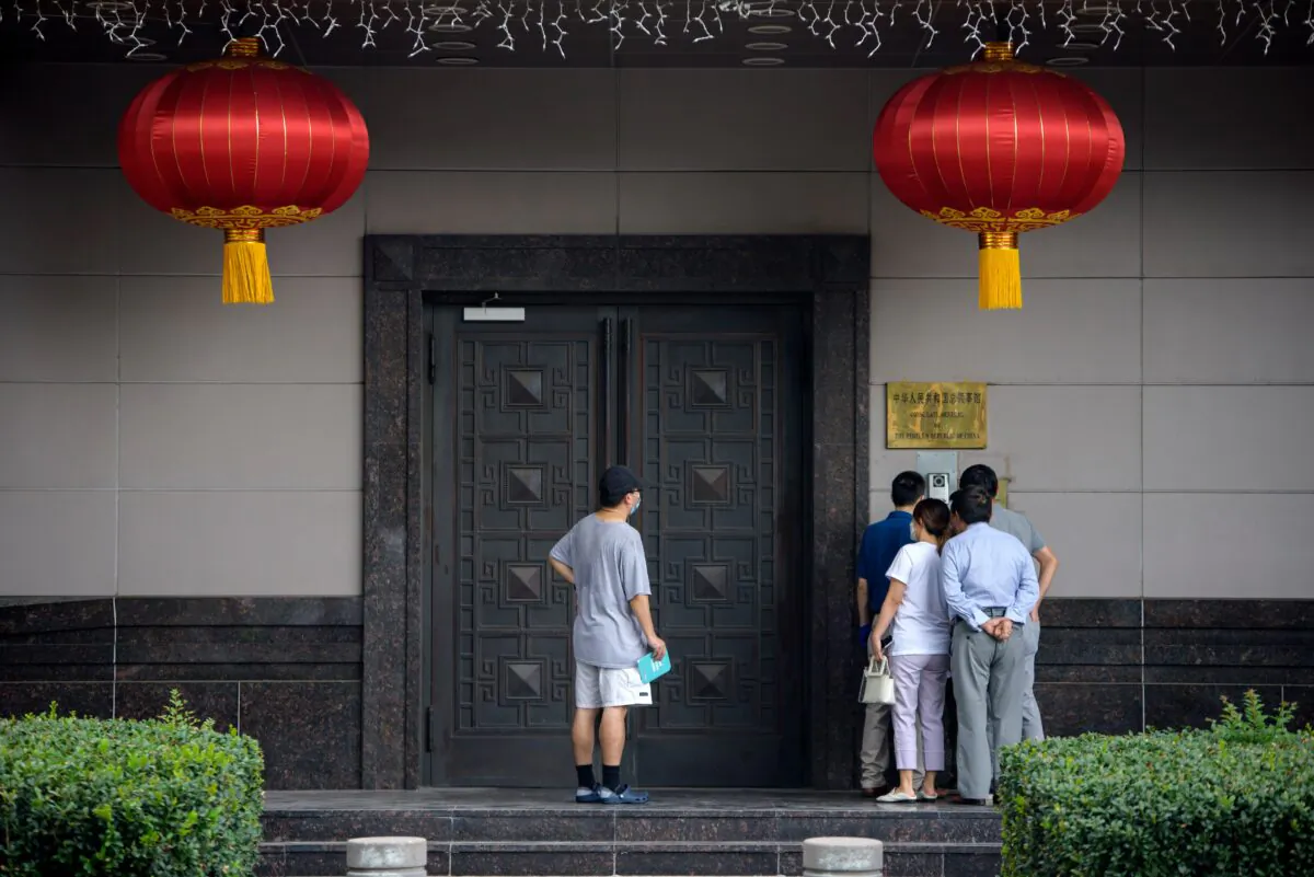 People attempt to talk to someone at the Chinese consulate in Houston on July 22, 2020. (Mark Felix/AFP via Getty Images)