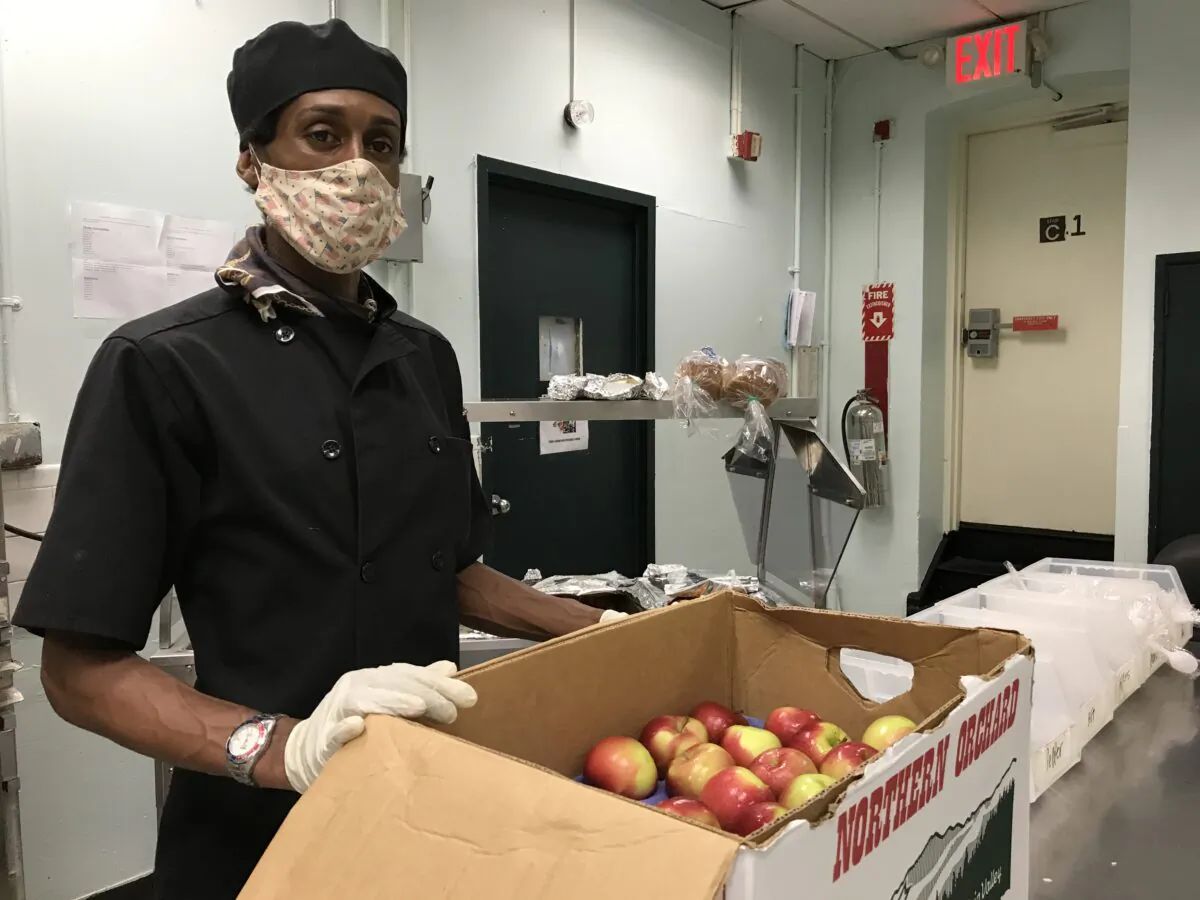 Lawrence Linton handles apples at a City Beet Kitchen. (Courtesy of City Beet Kitchens)