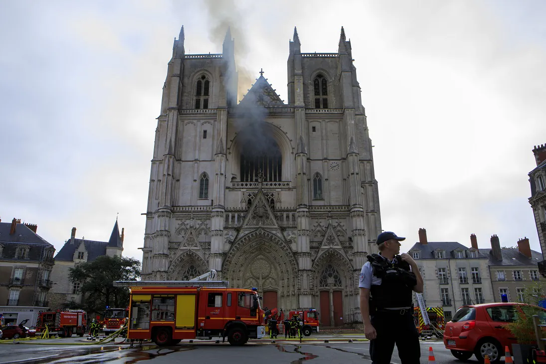 A fire fighters brigade works to extinguish the blaze at the Gothic St. Peter and St. Paul Cathedral, in Nantes, western France, on July 18, 2020. (Laetitia Notarianni/AP Photo)