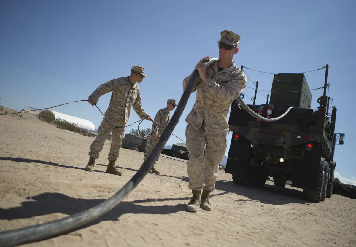 U.S. Marine Corps Cpl. Hunter, Jake, a radar technician, pulls the generator power cable to the Ground/Air Task Oriental Radar (G/ATOR) on Sept. 16, 2015 at Cannon Air Defense Complex (P111), Yuma, Ariz. (U.S. Marine Corps photo by Cpl. Summer Dowding MAWTS-1 COMCAM/ Released)