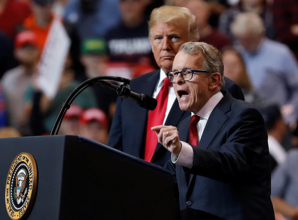 President Donald Trump listens as Ohio gubernatorial nominee and Ohio Governor Mike Dewine speaks during a campaign rally in Cleveland, Ohio., on Nov 5, 2018. (Reuters/Carlos Barria)