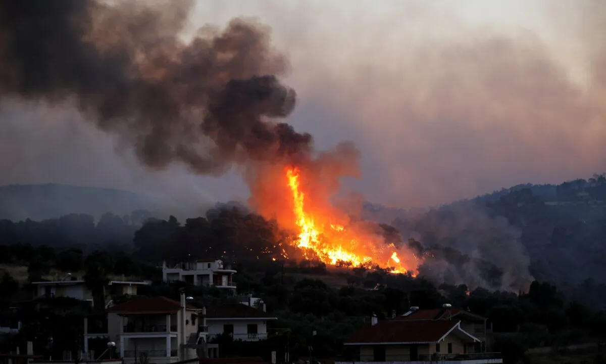 Flames rise as a wildfire burns near the village of Kechries, Greece, on July 22, 2020. (Costas Baltas/Reuters)