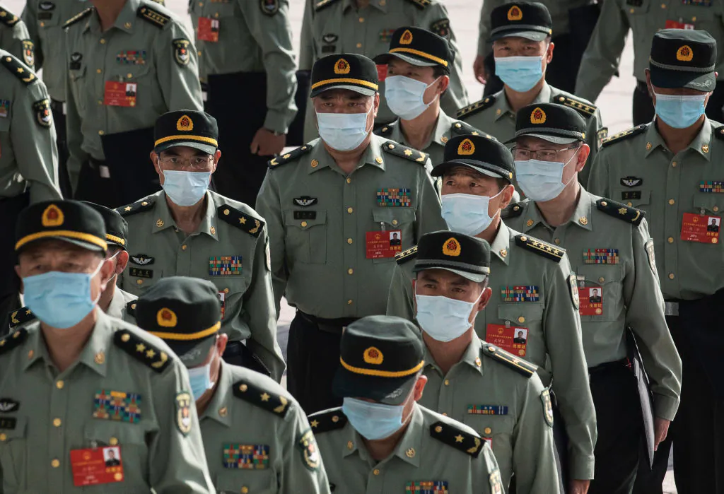 Delegates from China's Armed Forces wear protective masks as they arrive to the opening of the National People's Congress at the Great Hall of the People in Beijing on May 22, 2020. (Kevin Frayer/Getty Images)