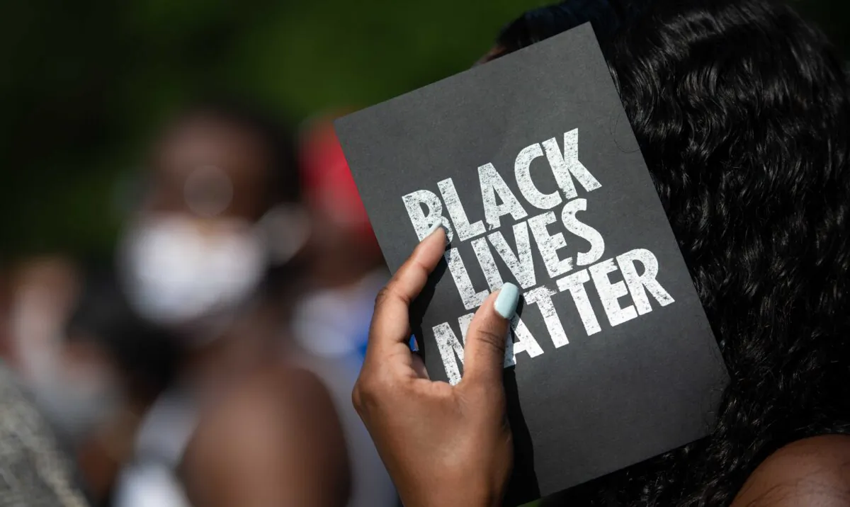 A demonstrator holds a card that reads "Black Lives Matter," outside of the Glynn County courthouse in Brunswick, Ga., on June 4, 2020. (Sean Rayford/Getty Images)
