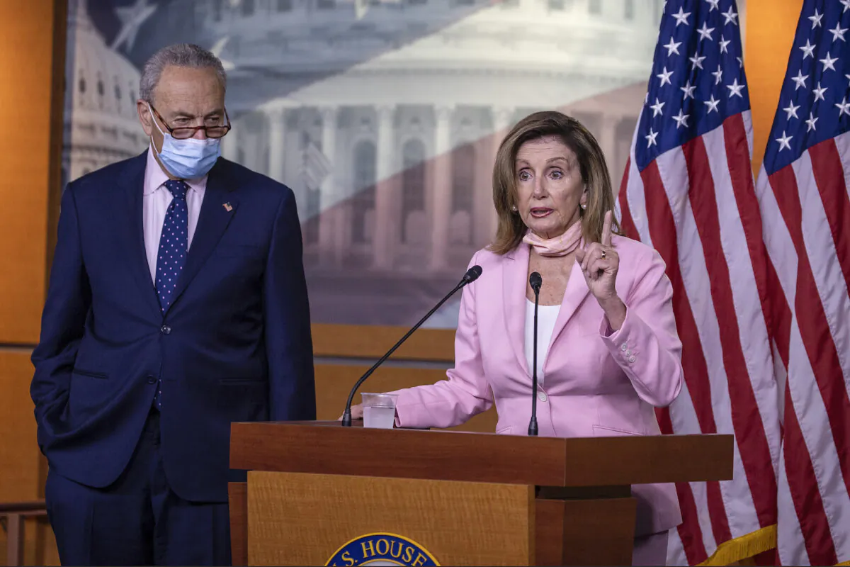 Speaker of the House Nancy Pelosi (D-CA) speaks as Senate Minority Leader Chuck Schumer (D-NY) listens during a press briefing in Washington on July 23, 2020. (Tasos Katopodis/Getty Images)