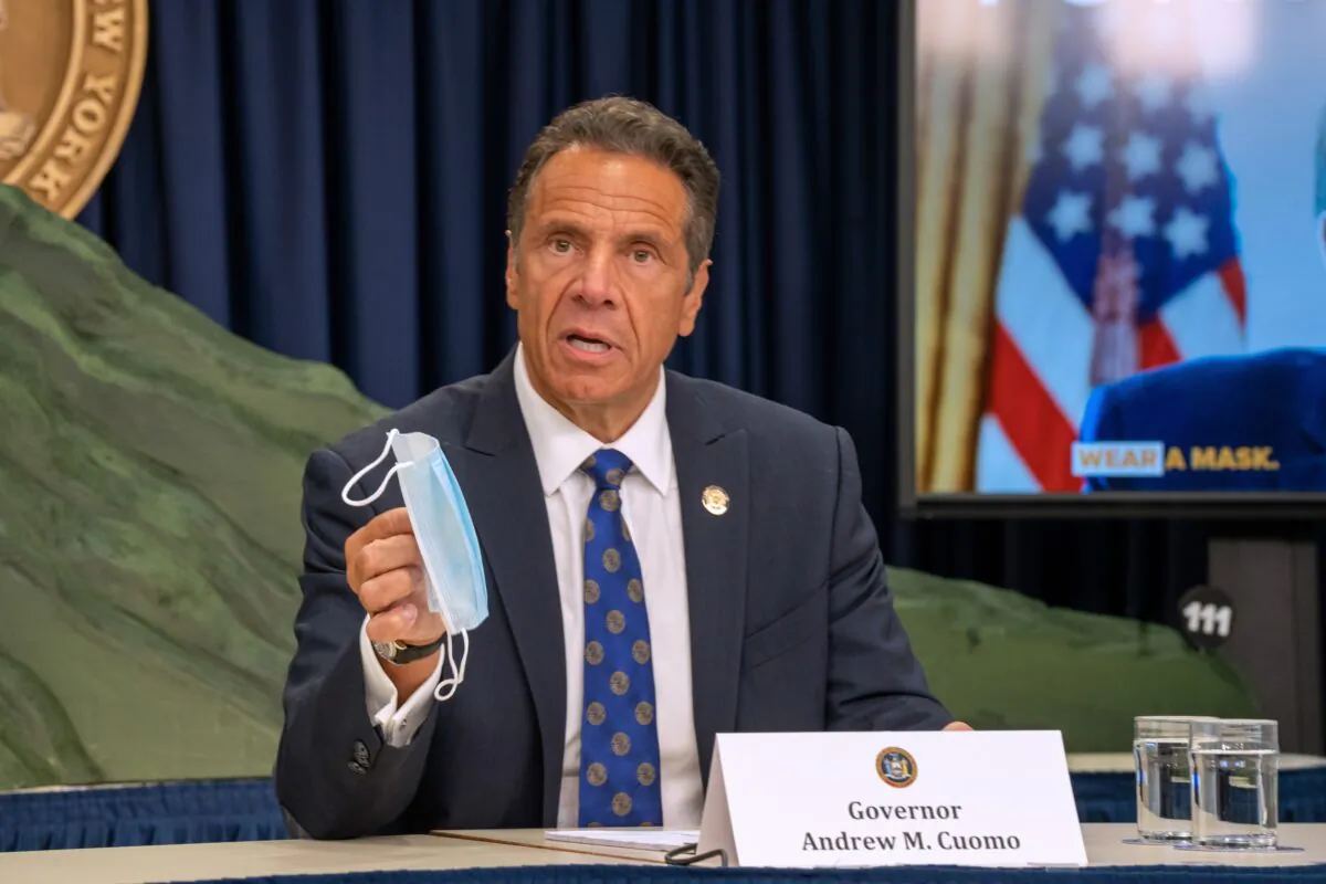 New York Gov. Andrew Cuomo holds a mask during a briefing in New York City, on July 6, 2020. (David Dee Delgado/Getty Images)