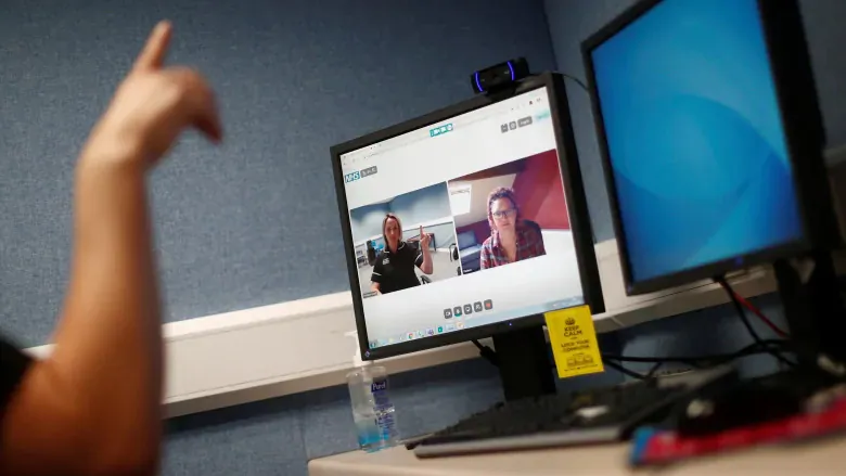 A speech therapist conducts a therapy session with a patient using the Zoom online conferencing platform on May 14, 2020. A large number of Canadians compelled to work from home during the pandemic lockdown are expected to claim a federal tax break for home offices. (Hannah McKay/Associated Press)