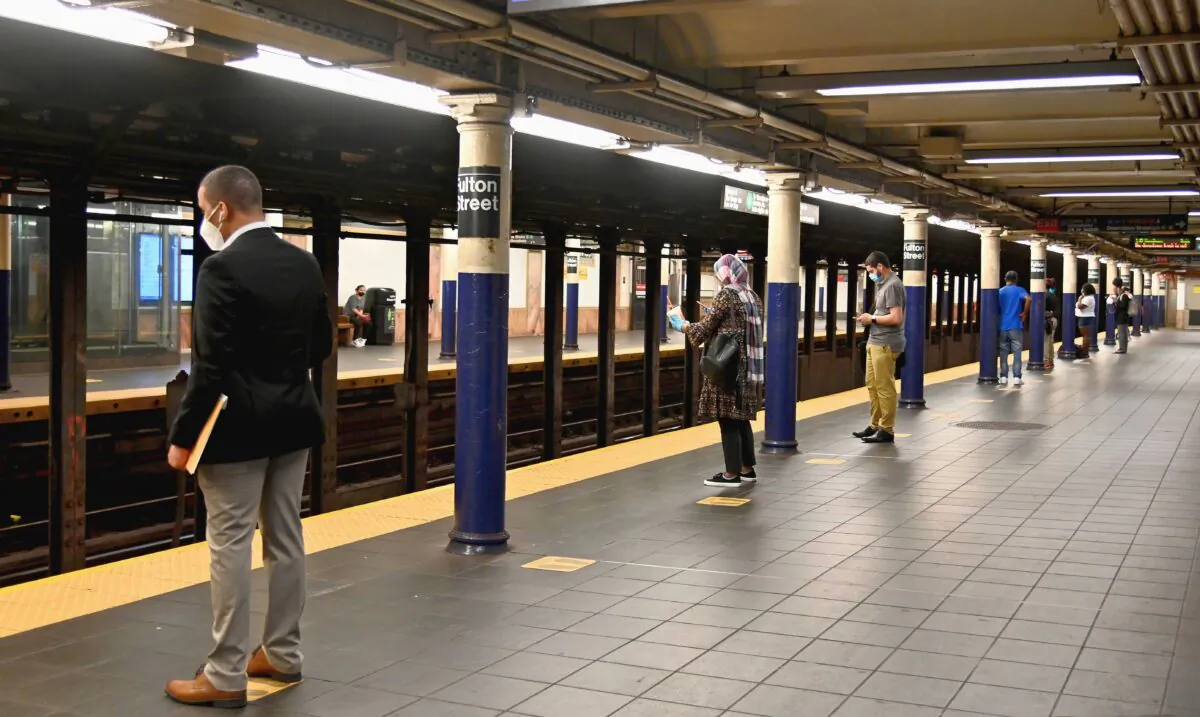 Commuters social distance while waiting for a train at the Fulton Street subway station and complex in lower Manhattan, New York City, on July 7, 2020. (Angela Weiss/AFP via Getty Images)
