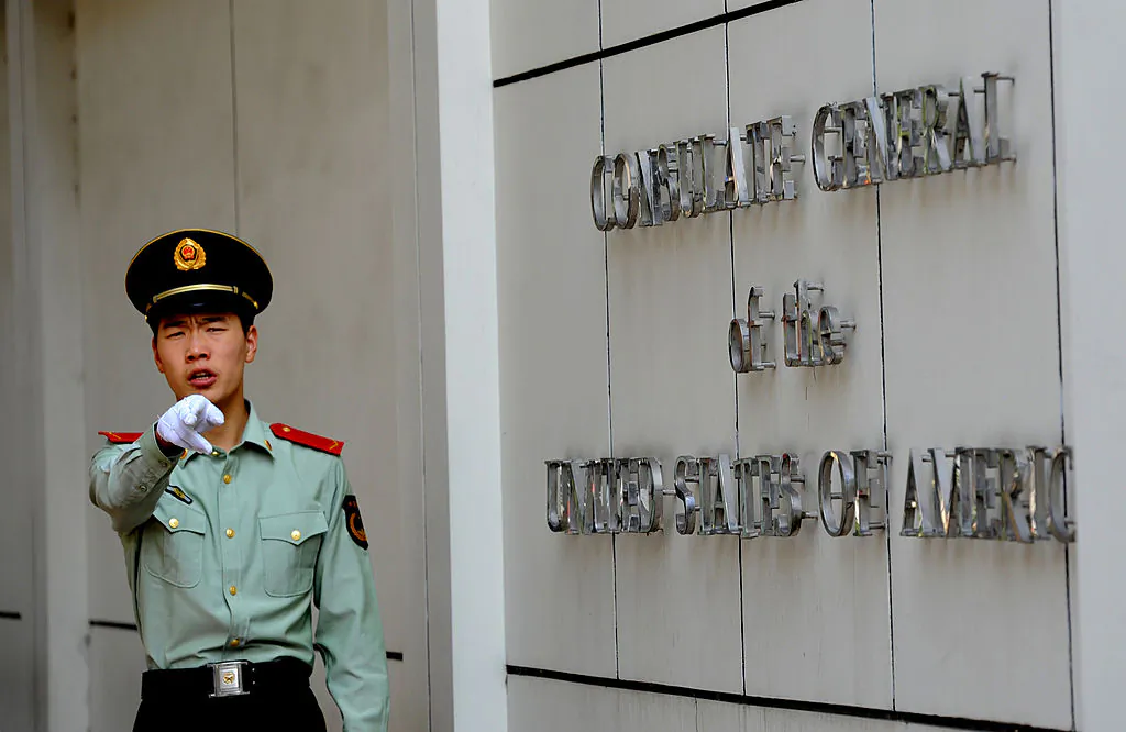 A Chinese paramilitary policeman gestures to photographers at the entrance to the US consulate in Chengdu, southwest China's Sichuan province on September 17, 2012. (Goh Chai Hin/AFP/GettyImages)
