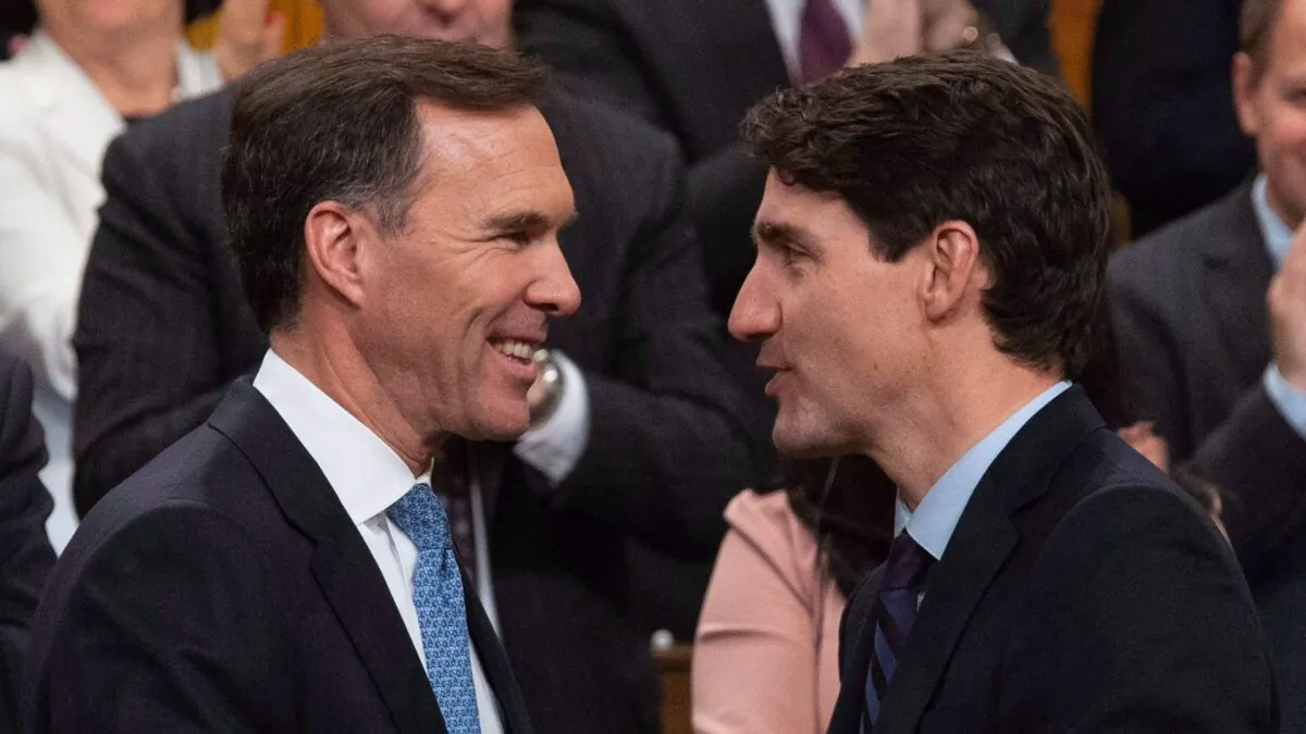 Canadian Prime Minister Justin Trudeau congratulates Minister of Finance Bill Morneau following the fall fiscal update in the House of Commons in Ottawa, on Nov. 21, 2018. (The Canadian Press/Adrian Wyld)