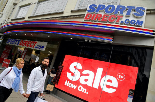 Shoppers walk past a branch of Sports Direct in Oxford Street London