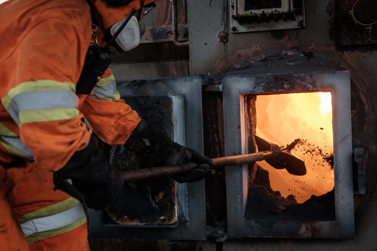 A worker puts Vanadium in a kiln at Canadian based Strategic Mineral Company Largo Resources' Vanadium plant, near Maracas, in Bahia state, Brazil, on June 15, 2016.
Vanadium is primarily used as an alloy to strengthen steel for construction, automobile and aerospace industries. (Yasuyoshi Chiba/AFP via Getty Images)
